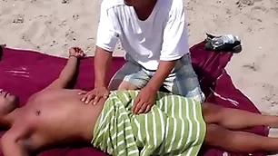 Nipple & penis rub down on a public seaside