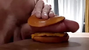Muscular horny teen fucks a burger with a big dig up and cums in it